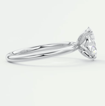 White gold solitaire diamond engagement ring with a marquise-shaped stone.