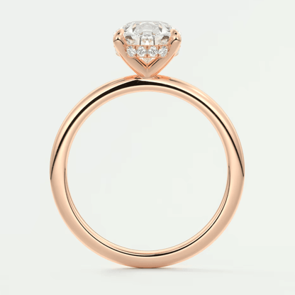Rose gold diamond engagement ring with a halo design and small diamonds on the band.