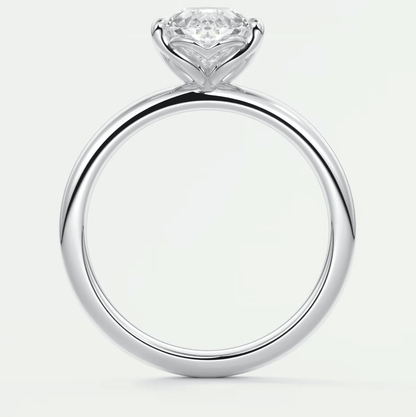 18-karat white gold engagement ring with a round diamond center stone and pave-set diamonds on the band.