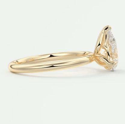 18k yellow gold engagement ring with a marquise-cut diamond and small accent diamonds.