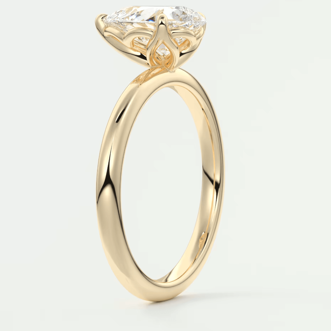 18-karat yellow gold engagement ring with a large, round diamond.