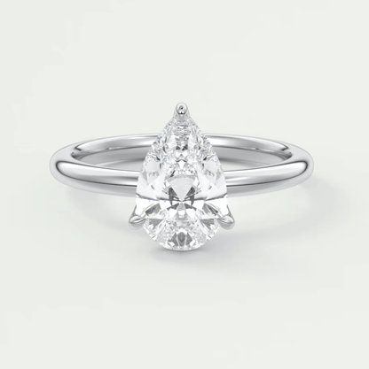 Pear-shaped diamond engagement ring with a white gold band and prong setting.