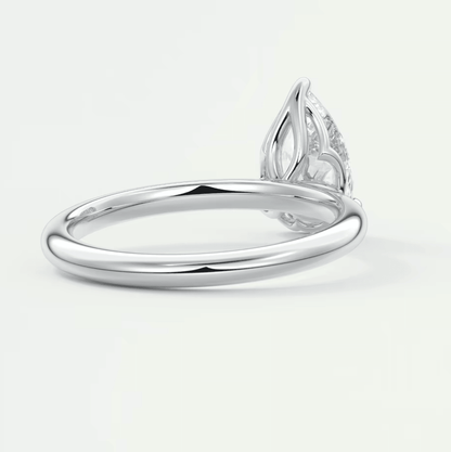 White gold diamond engagement ring with a marquise-cut stone and intricate leaf design on the band.