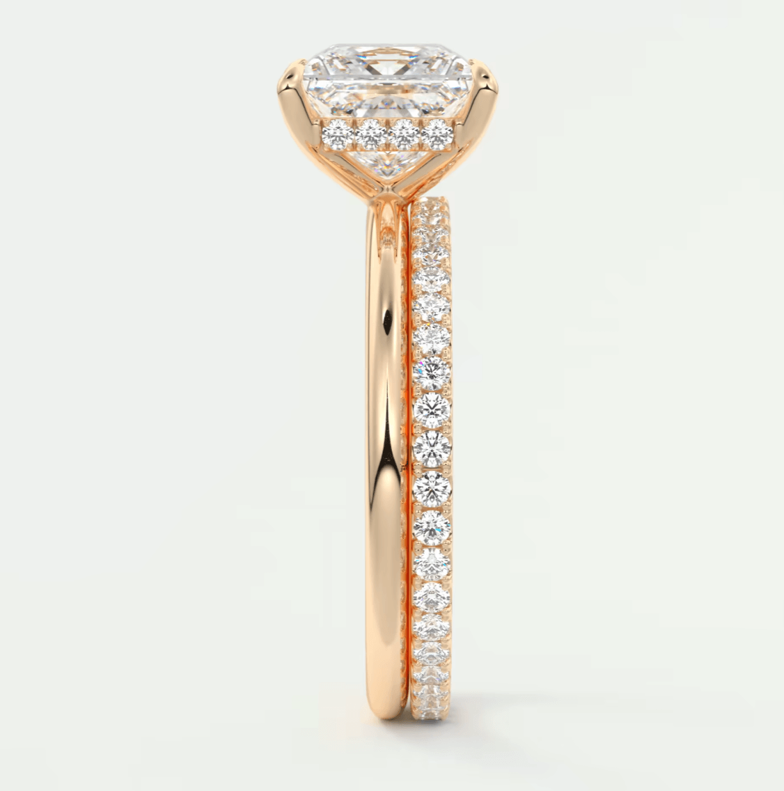 18k rose gold diamond engagement ring with a halo setting and pave band.