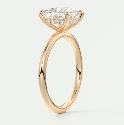 18-karat rose gold engagement ring with princess-cut diamond and pave-set diamonds on the band.