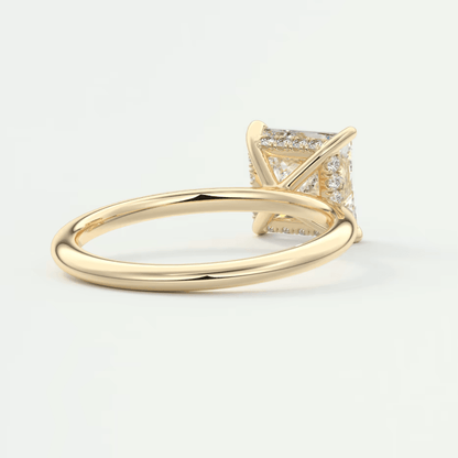 18k yellow gold princess cut diamond engagement ring with a halo of smaller diamonds.
