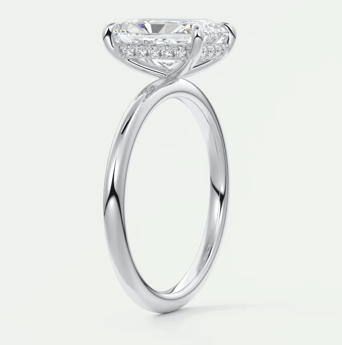 18-karat white gold engagement ring with a princess-cut diamond and pavé-set diamonds on the band.