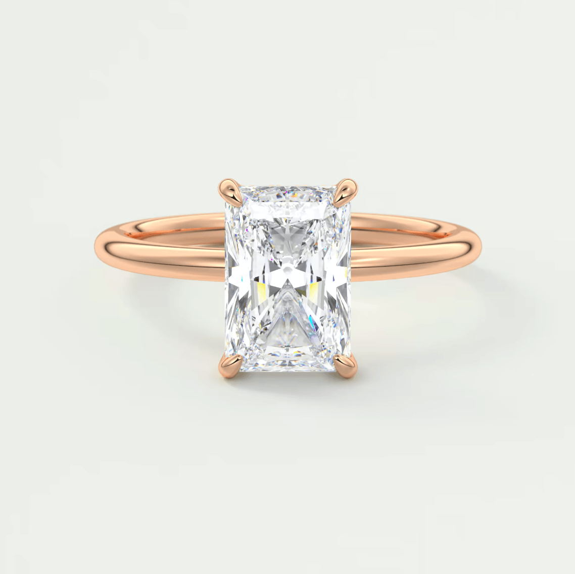 18-karat rose gold engagement ring with a radiant cut diamond.