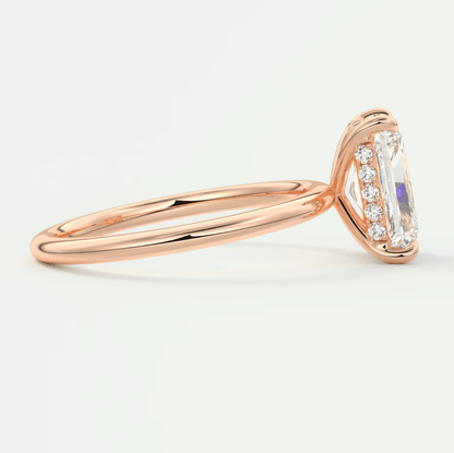 18k rose gold engagement ring with emerald-cut diamond and halo design.
