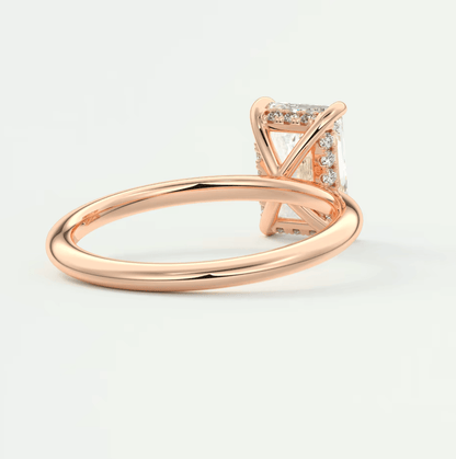 Rose gold princess cut diamond engagement ring with a halo of smaller diamonds around the center stone.