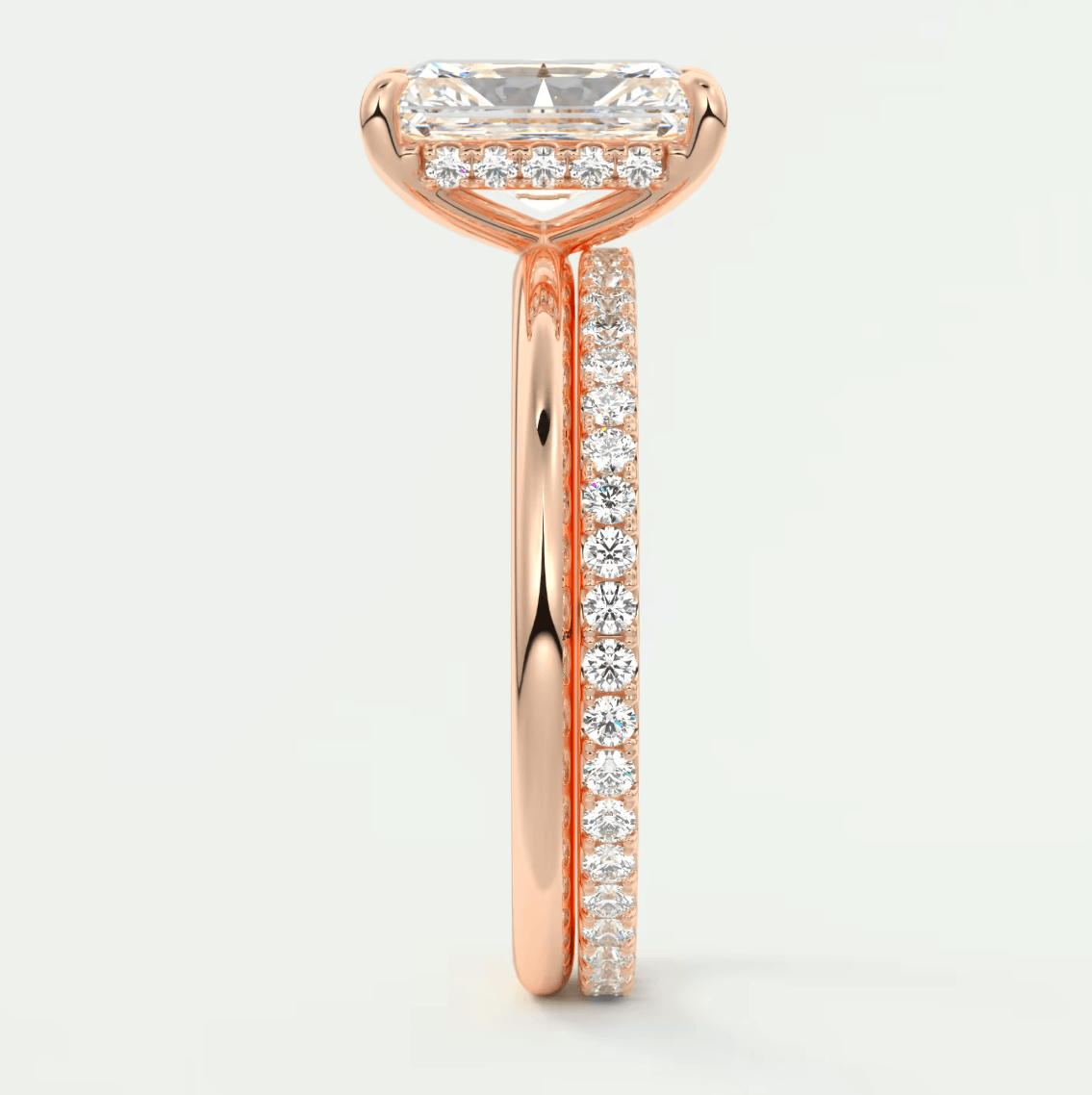 18k rose gold engagement ring with a marquise-cut diamond and pavé set diamonds on the band.