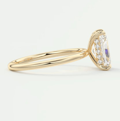 18k yellow gold engagement ring with emerald-cut diamond and small round diamonds set in a halo design.