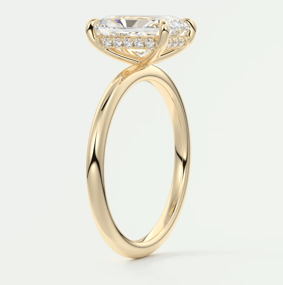 18k yellow gold engagement ring with a princess cut diamond and halo of smaller diamonds.