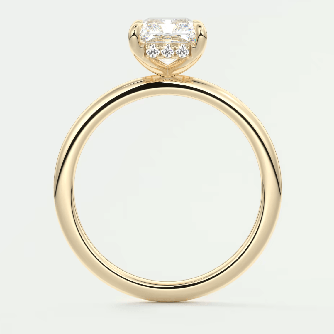 18k yellow gold engagement ring with a cushion-cut diamond and small round diamonds on the band.
