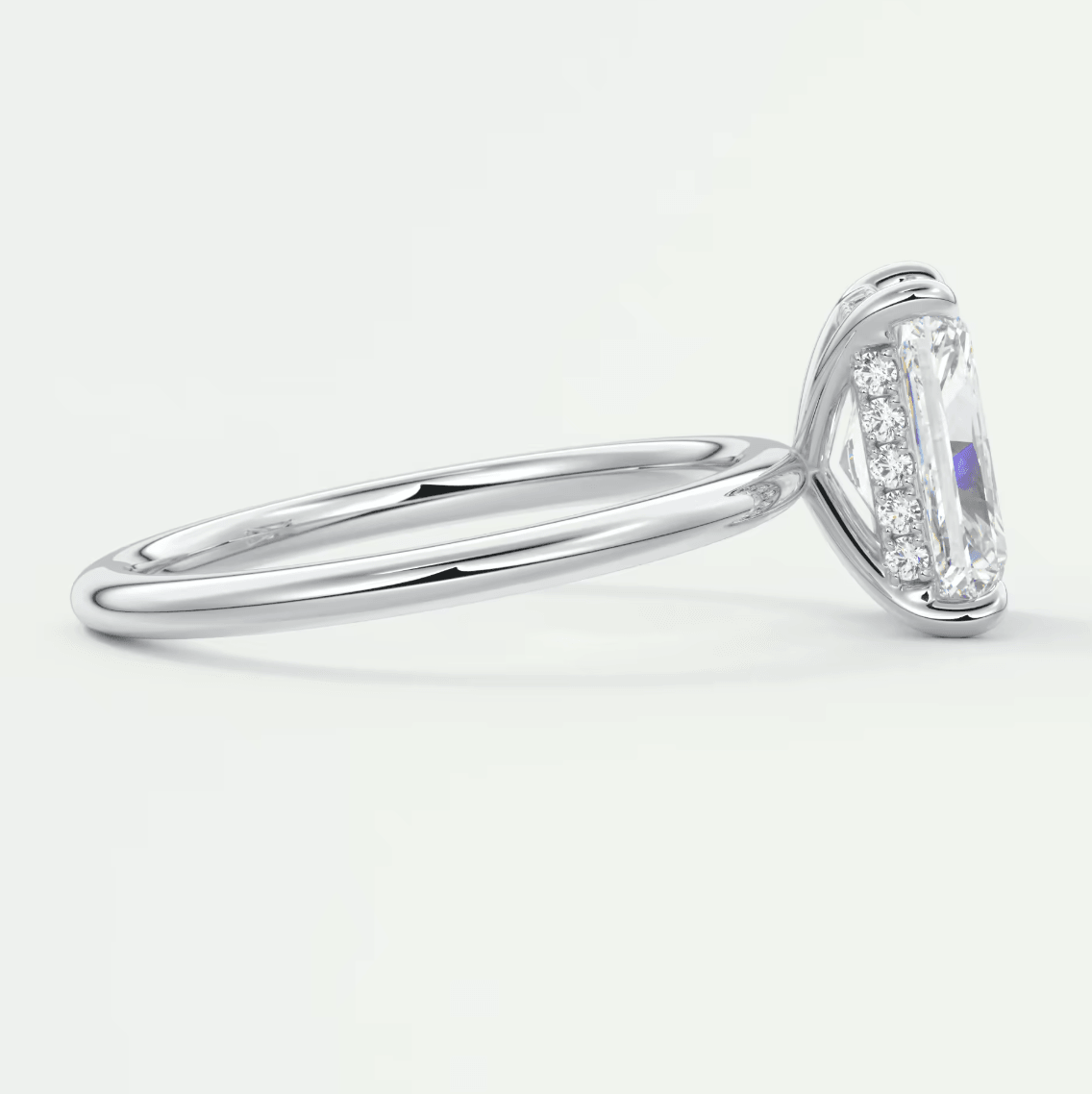 18k white gold diamond engagement ring with an emerald-cut center stone and halo of smaller diamonds.