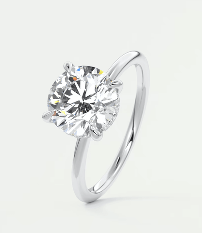 18-karat white gold solitaire diamond engagement ring.