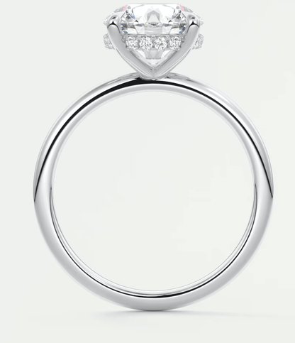 White gold diamond engagement ring with a princess cut center stone and small diamonds on the band.