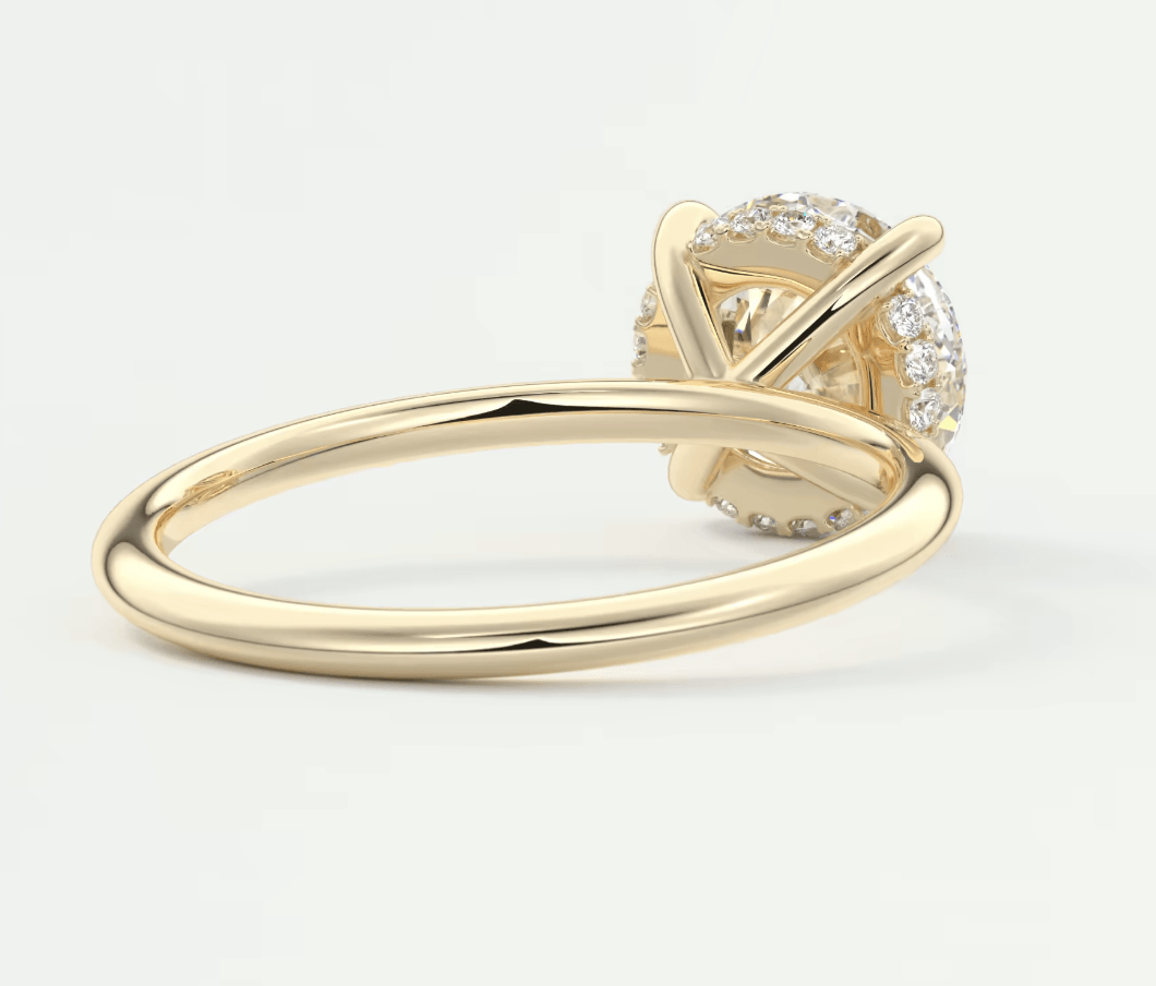 18k yellow gold diamond engagement ring with a solitaire design and halo of smaller diamonds.