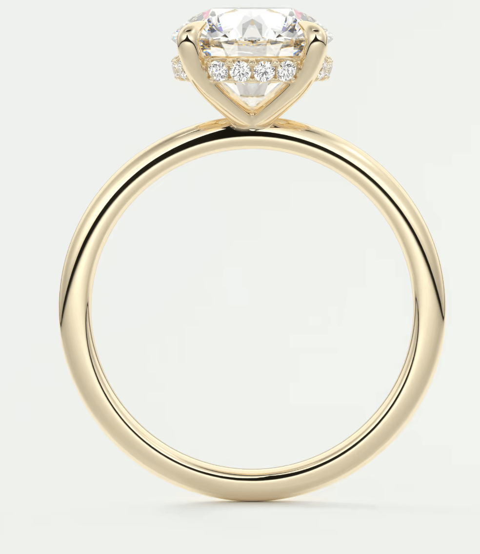 18-karat yellow gold engagement ring with a cushion-cut diamond and small diamonds set in the band.