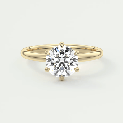 18k yellow gold solitaire diamond engagement ring with a round brilliant cut stone.