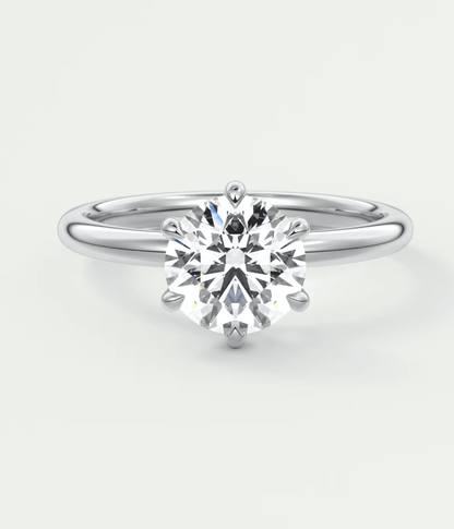 18k white gold solitaire diamond engagement ring with a round brilliant cut stone.
