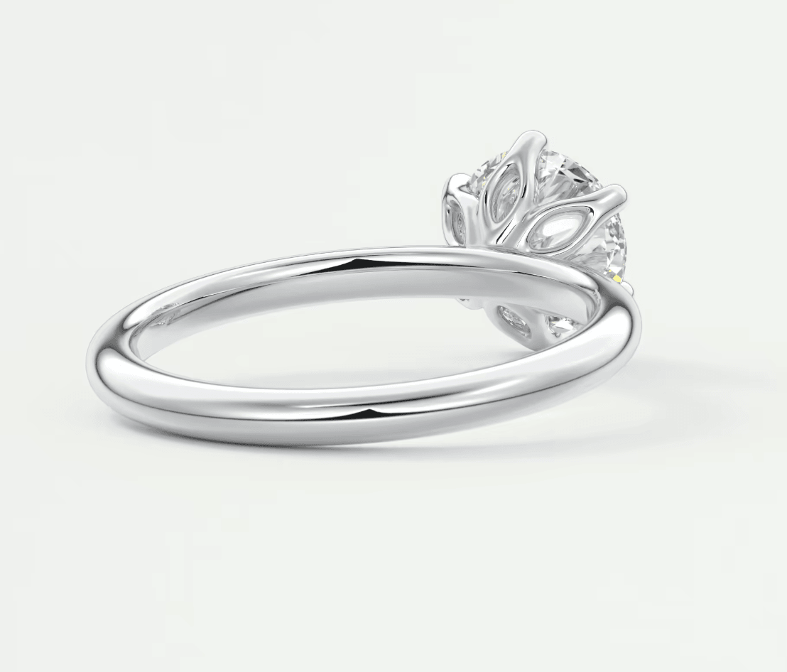 18k white gold diamond engagement ring with a leaf-inspired setting.