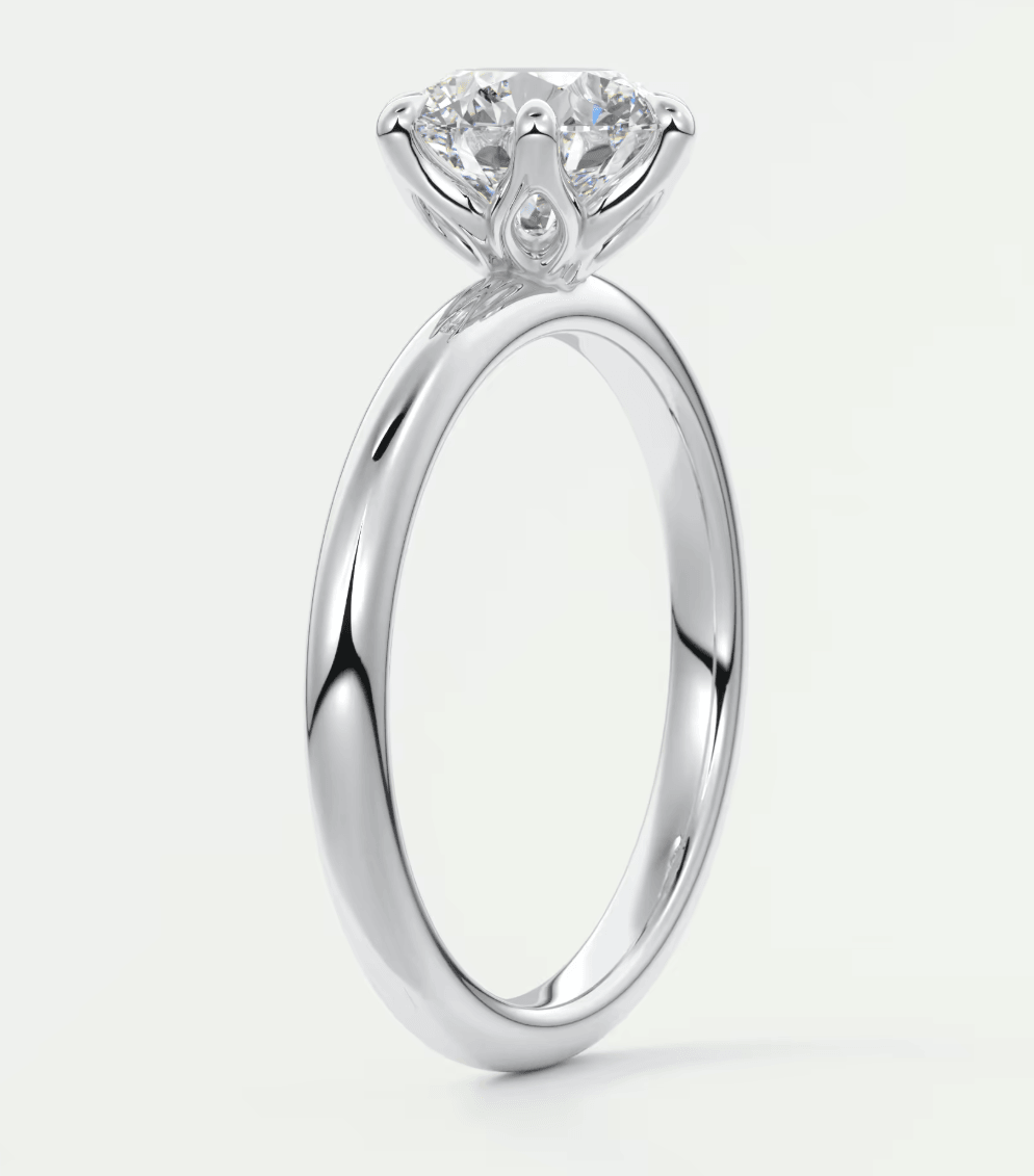 18-karat white gold solitaire diamond engagement ring with a round brilliant cut stone.