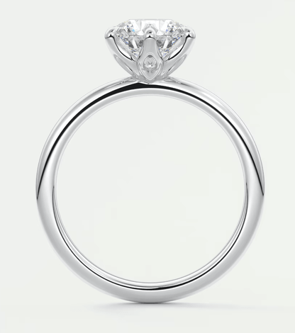 18k white gold solitaire diamond engagement ring with a pear-shaped accent stone.