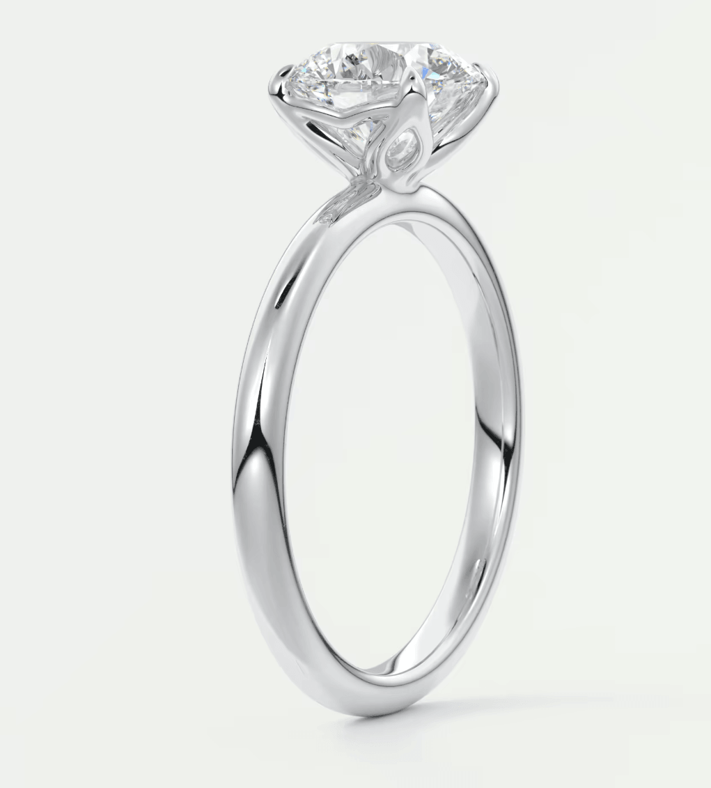 18-karat white gold engagement ring with a round diamond.