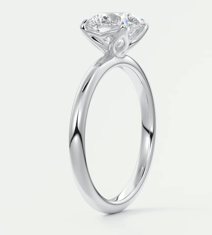 18-karat white gold engagement ring with a round diamond.