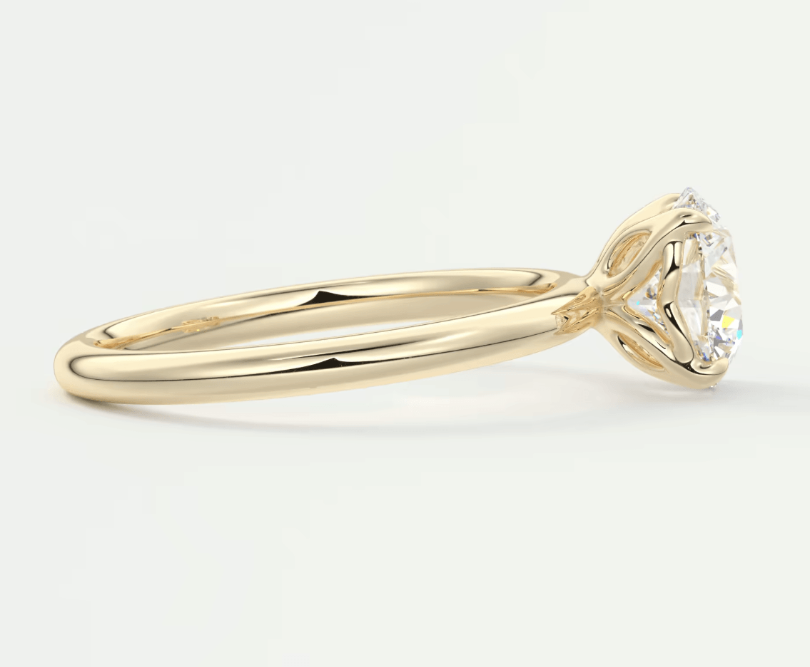 18k yellow gold solitaire diamond engagement ring with a round brilliant cut stone.
