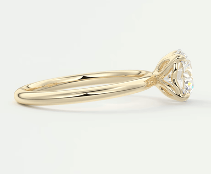 18k yellow gold solitaire diamond engagement ring with a round brilliant cut stone.