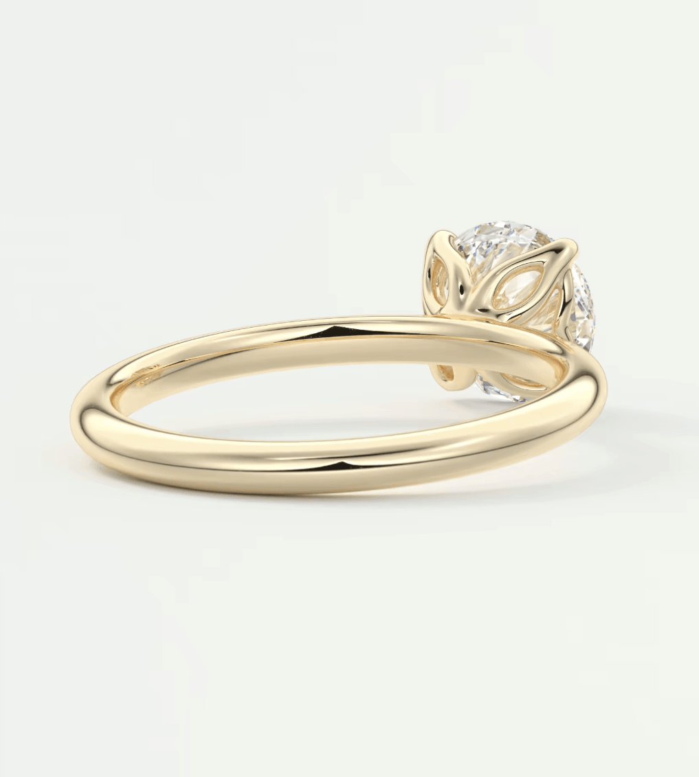 18k yellow gold diamond engagement ring with leaf-inspired design.