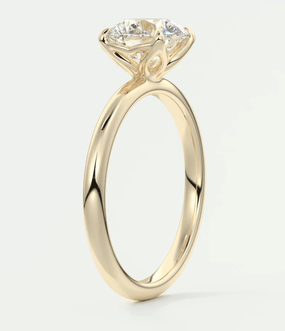 18-karat yellow gold engagement ring with a round diamond.