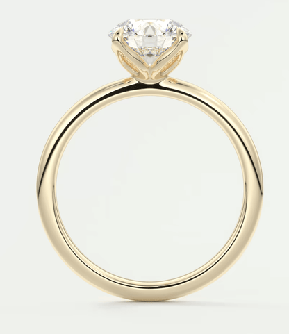 18k yellow gold engagement ring with a cushion-cut diamond.