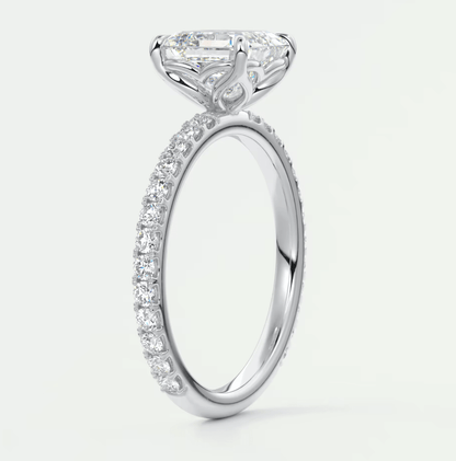 18k white gold engagement ring with a princess cut diamond and pavé set diamonds on the band.