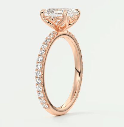 Rose gold diamond engagement ring with a marquise-cut center stone and pavé set diamonds on the band.