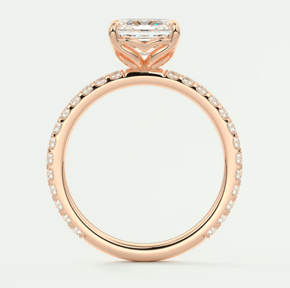 18k rose gold engagement ring with a princess cut diamond and pavé set diamonds on the band.