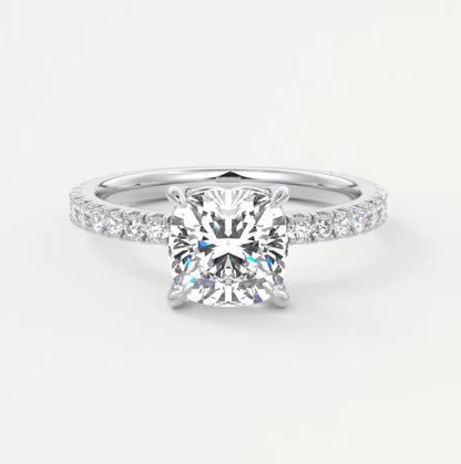 Princess cut diamond engagement ring with white gold band and pave set diamonds.
