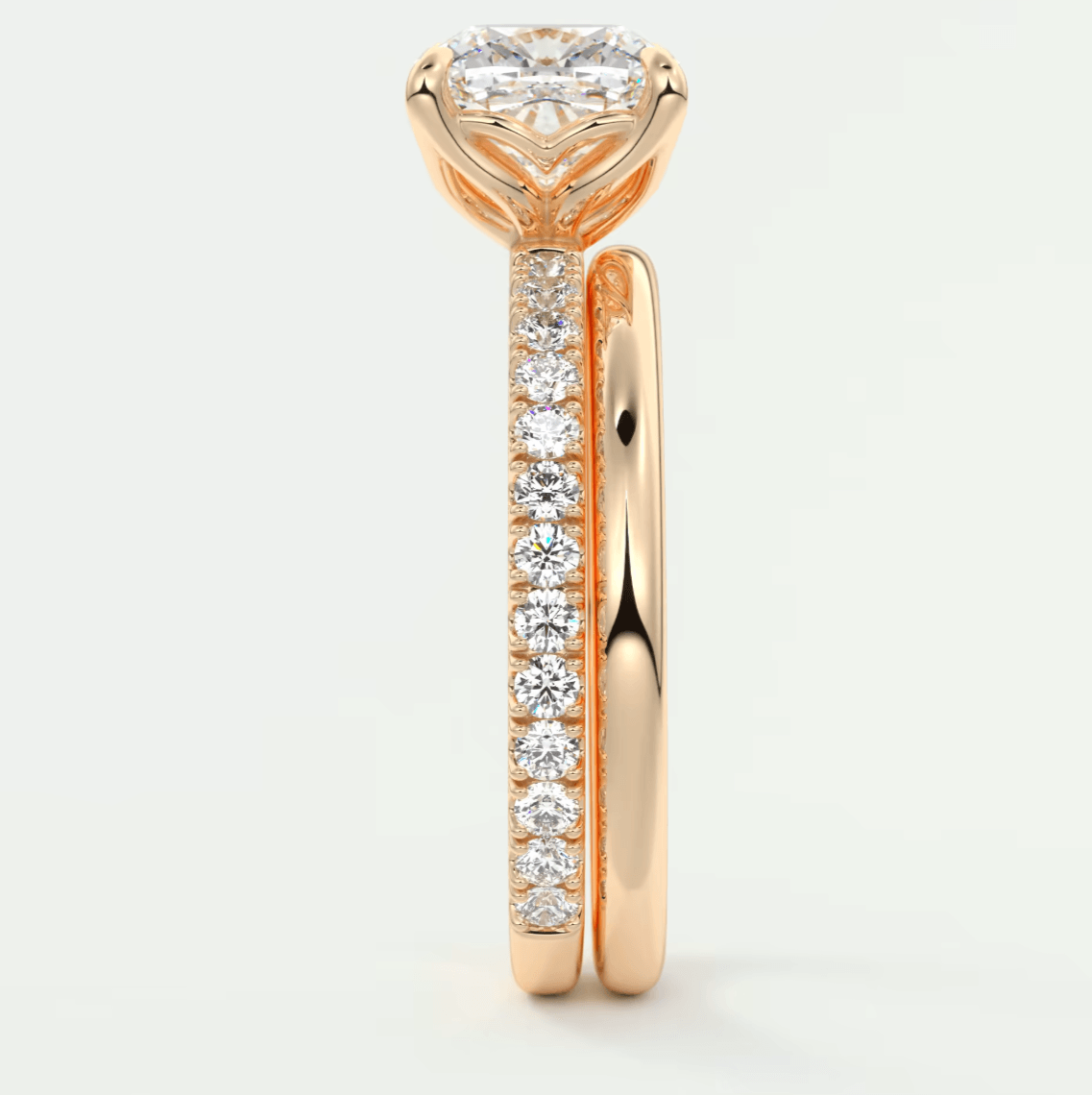 18k rose gold diamond engagement ring with a heart-shaped center stone and pave set diamonds on the band.