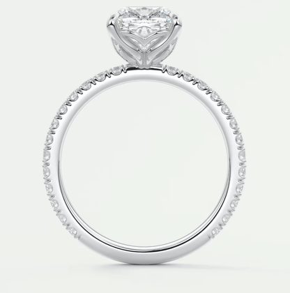 18k white gold heart-shaped diamond engagement ring with a halo of smaller diamonds.