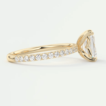 18k yellow gold engagement ring with an emerald-cut diamond center stone and a pave-set band.
