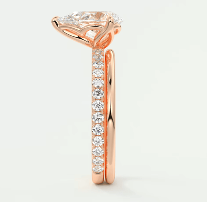 Rose gold diamond engagement ring with a princess cut center stone and pave set side stones.