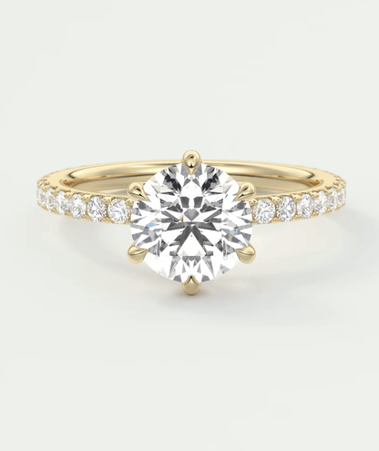 18k yellow gold diamond engagement ring with a round brilliant cut center stone and pave set diamonds on the band.