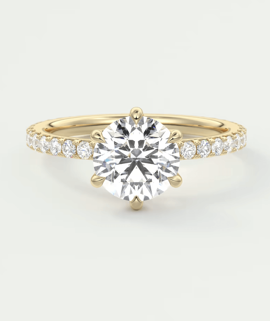 18k yellow gold diamond engagement ring with a round brilliant cut center stone and pave set diamonds on the band.