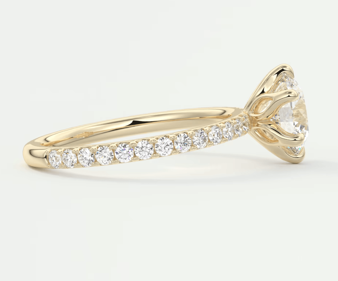 18k yellow gold diamond engagement ring with a round brilliant cut center stone and channel set diamonds on the band.