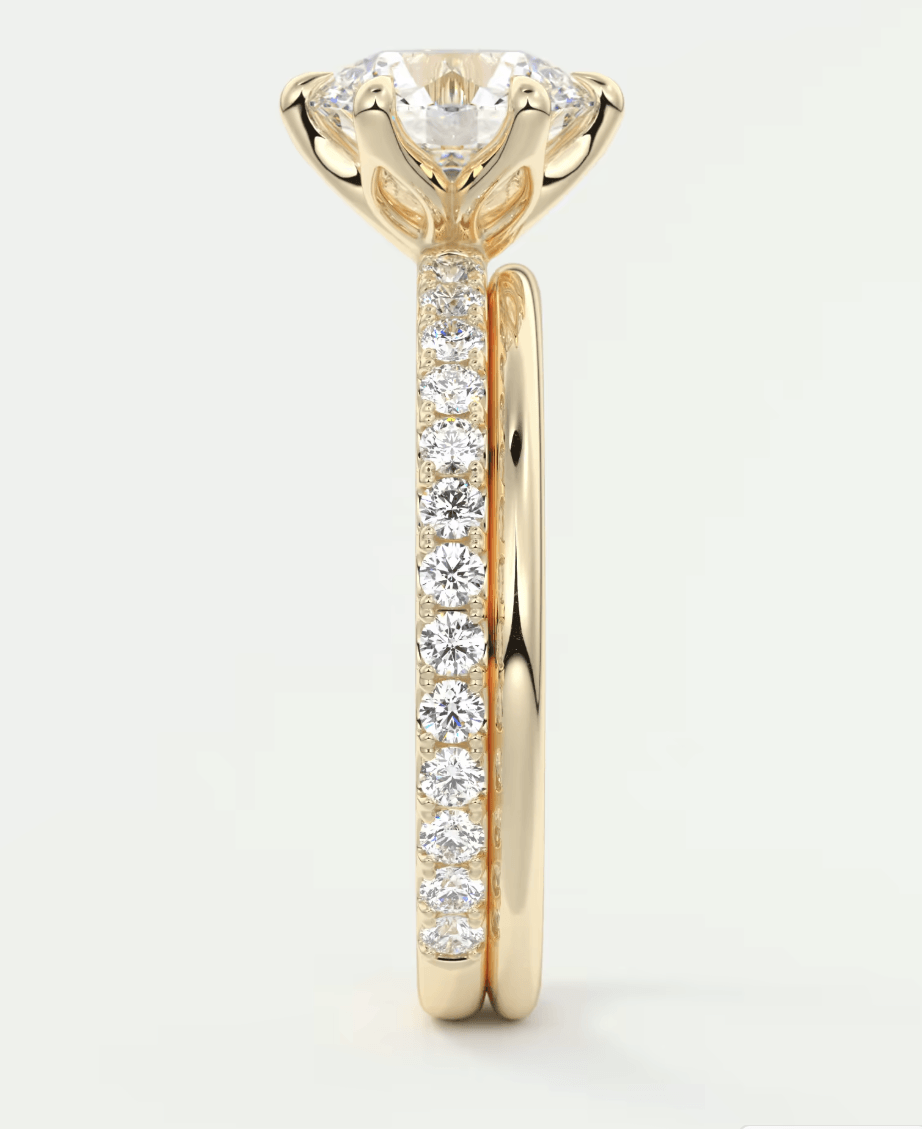 18-karat gold diamond engagement ring with a round-cut center stone and channel-set side diamonds.