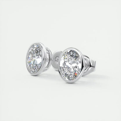 White gold oval diamond stud earrings with bezel setting.