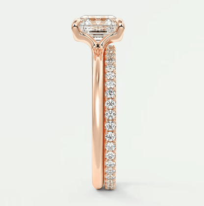 18-karat rose gold engagement ring with a princess-cut diamond and pave-set diamonds on the band.