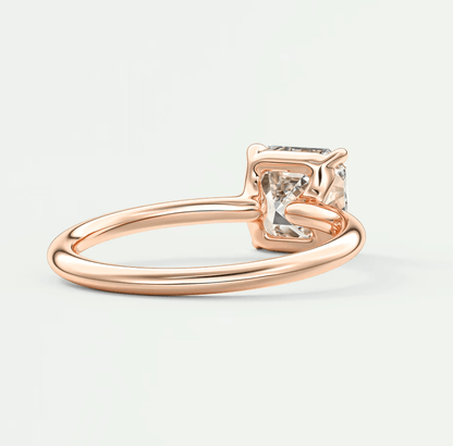 Rose gold princess cut diamond engagement ring with a square-shaped stone and four prongs.